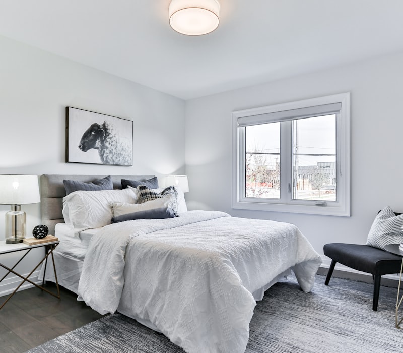 Bedroom with a made double bed and side tables